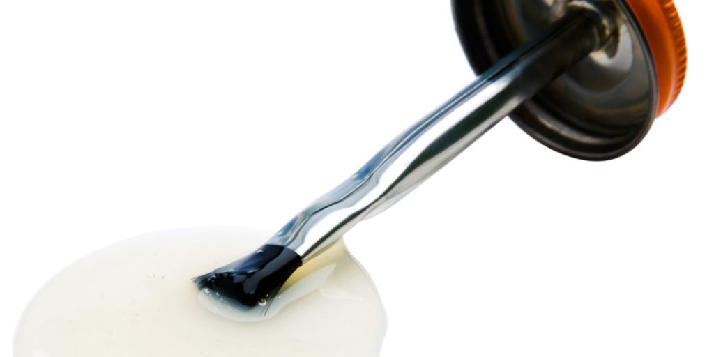 Brush of glue isolated over white